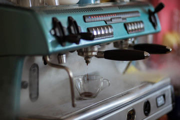 men's hands doing espresso in a cafe