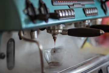 men's hands doing espresso in a cafe