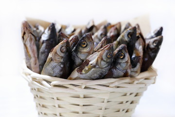 Dried fish to beer close-up in wicker basket