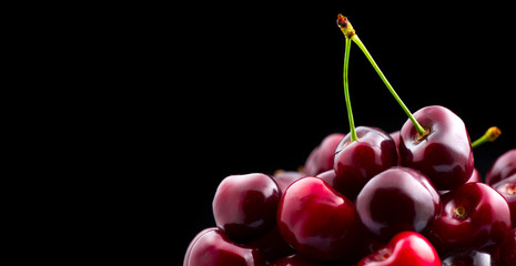 Cherry closeup. Organic ripe cherries isolated on black background - Powered by Adobe