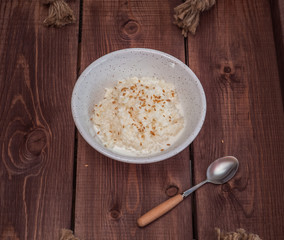 Breakfast of rice porridge on milk, sprinkled with flaxseeds
