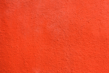 Fototapeta premium Bright orange painted stucco wall. Background texture.