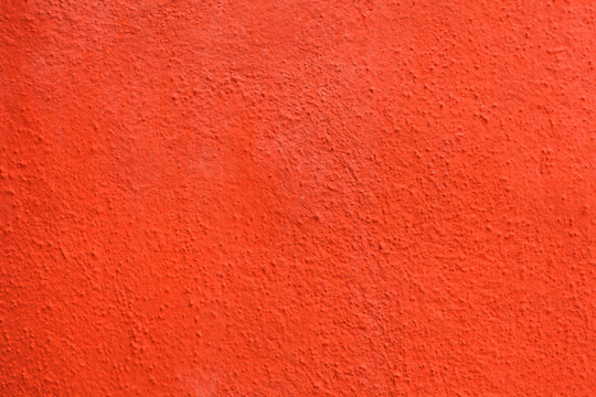 Bright orange painted stucco wall. Background texture.