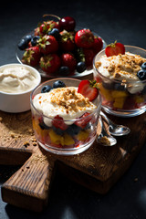 fresh fruit with custard in glasses, vertical top view