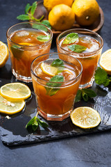 refreshing iced tea with mint and lemon, vertical, top view