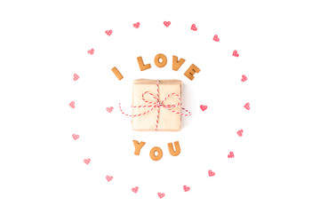 Valentine's day concept. Declaration of love, frame made of paper hearts. In the center gift in craft paper. Flat lay, top view, white background, isolated, copy space