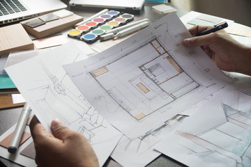 Architect designer Interior creative working hand drawing sketch plan blue print selection material...