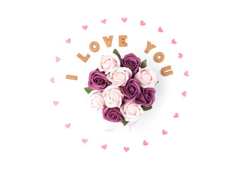 Valentine's day concept. Declaration of love, frame made of paper hearts. In the center flowers in a box. Flat lay, top view, white background, isolated, copy space