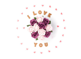 Valentine's day concept. Declaration of love, frame made of paper hearts. In the center flowers in a box. Flat lay, top view, white background, isolated, copy space