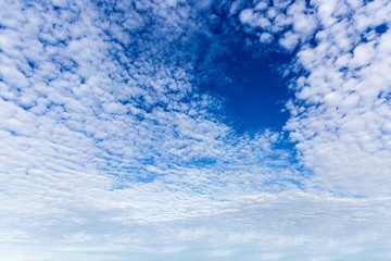 blue sky background with tiny clouds