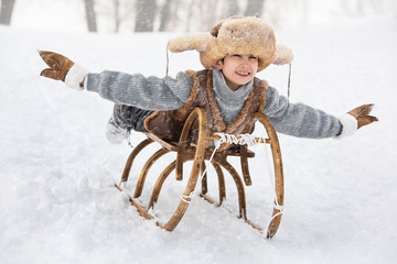 Child slide down hills on sleds