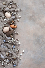 Easter decoration – natural eggs and pussy willow. Top view, close up, flat lay on light concrete background