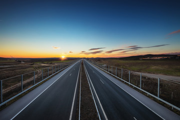 Aerial view of highway and beautiful sunset, travel around the world