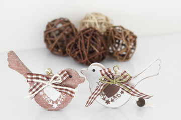 Valentine's day concept. Couple in love, just married or honeymoon concept. Couple of wooden birds looking at each other with painted hearts and fabric bows with decor.