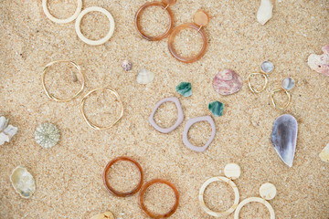 Handmade Jewelry on Sand Beach Top Down View