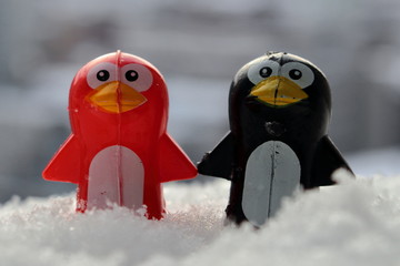 Valentine's day concept. Couple in love, just married or honeymoon concept. Couple of toy penguins in the snow.