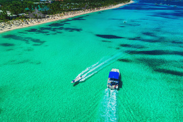 Aerial drone view over the seascape, catamaran boats in the Caribbean sea. Beach resort Punta Cana,...