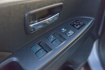 buttons of window regulators in an automobile door