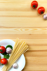 Italian pasta ingredients on the light wooden table