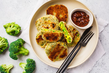 Green Veggie broccoli burgers in white dish on white background.