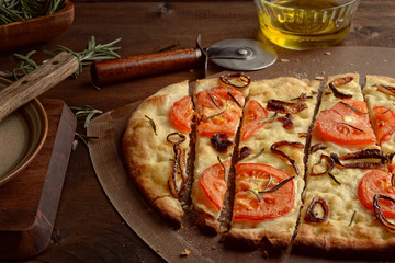  Closeup sliced Focaccia With Caramelized Onions Tomatoes and Fresh Rosemary