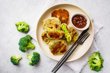 Green Veggie broccoli burgers in white dish on white background.