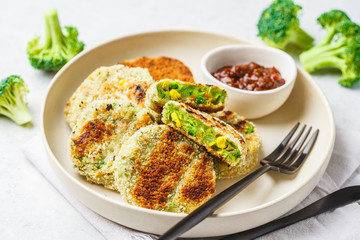 Green Veggie broccoli burgers in white dish on white background.