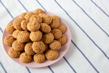Homemade almond cookies on pink plate, low angle view. Closeup.