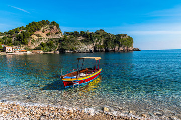 Excursion and tourist boat on the water, Isola Bella near Taormina in Sicily, Italy
