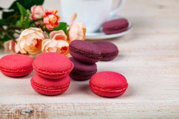 Berry macaroons. white cup and rose