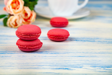 Berry macaroons. white cup and rose