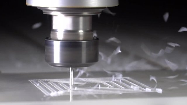 Slow motion. Milling machine makes plastic parts. The milling cutter processes.