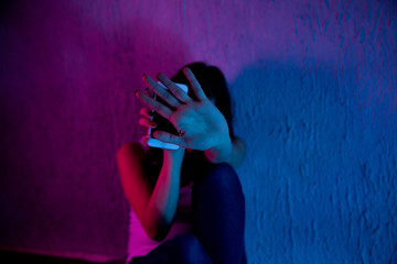 scared and sad female teenager with computer laptop suffering cyberbullying and harassment being online abused by stalker or gossip feeling desperate and humiliated in cyber bullying.