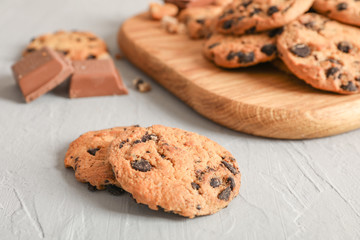Tasty homemade chocolate chip cookies on gray background
