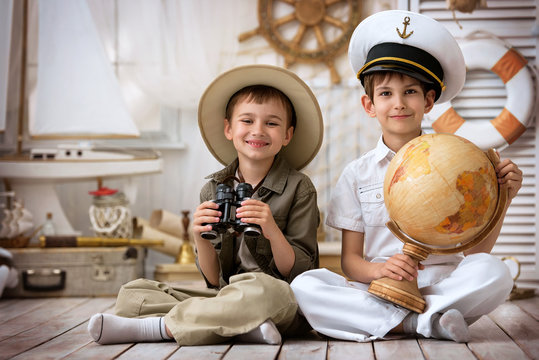 Boys in the form of traveler and the captain playing in his room
