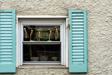 Fototapeta na wymiar skeletons hanging on a rope outside the window