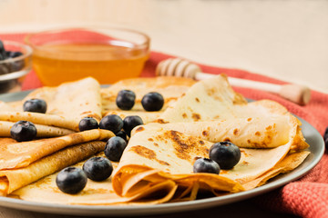 Fresh homemade crepes with blueberry and honey