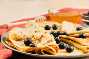 Fresh homemade crepes with blueberry and honey