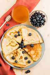 Fresh homemade crepes with blueberry and honey