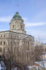 Scenic view of ancient building on hill in capital of Quebec province in Canada. Depressive beautiful winter look of historical construction in Quebec city