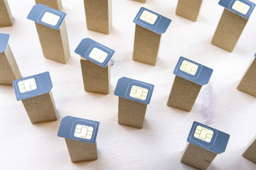 columns with SIM cards at the top are placed on a white surface wooden