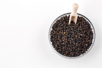Indian spices black pepper grains on white background