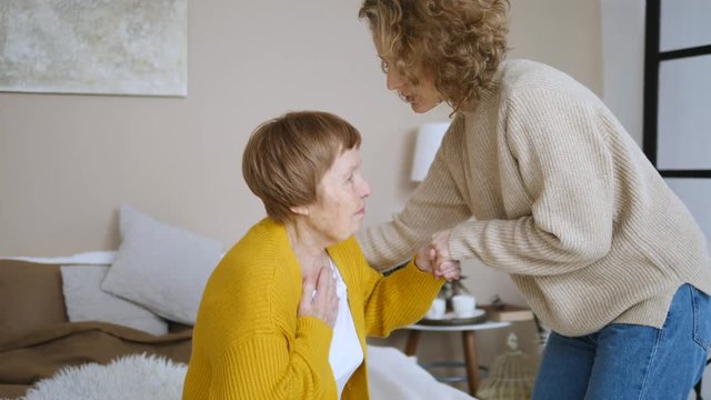 Elderly Care Concept. Granddaughter Taking Care Of Her Sick Senior Grandmother.