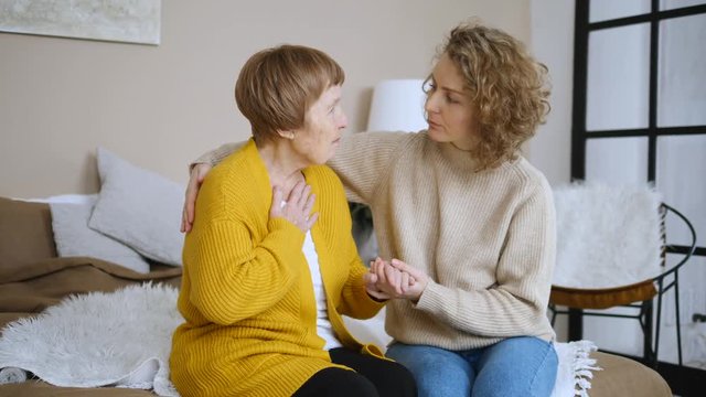 Sick Grandmother Complaining To Granddaughter. Elderly Care Concept.