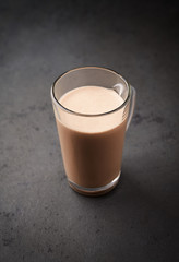 Chocolate Protein Shake. Nutrition for bodybuilding. Black stone background. Copy space.