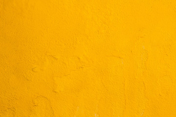Old cracked yellow painted wall background