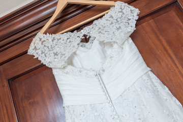 Fototapeta na wymiar Wedding dress hanging up before the ceremony