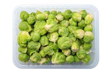 Brussels sprouts in a disposable container on a white background. View from above. The concept of healthy eating, diet. Isolated object