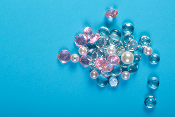 A scattering of white and pink stones with highlights on a blue background.