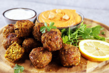 Traditional homemade hummus, falafel and chickpea served with spices on table. Jewish Cuisine.
